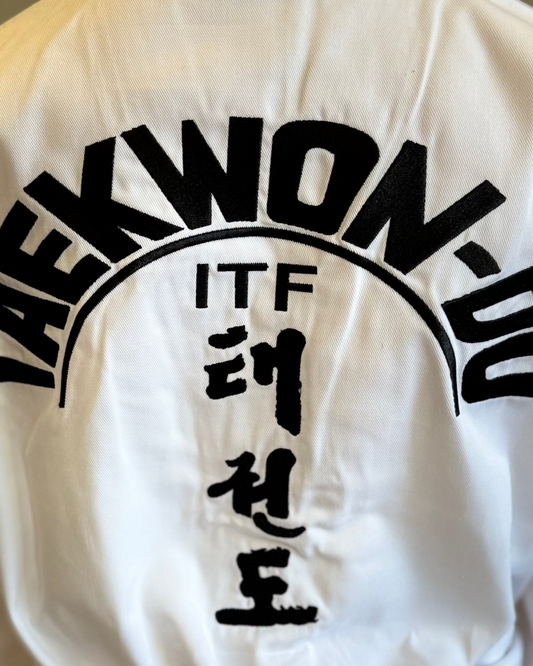 White Taekwondo uniform with 'ITF' and Korean text on the back.
