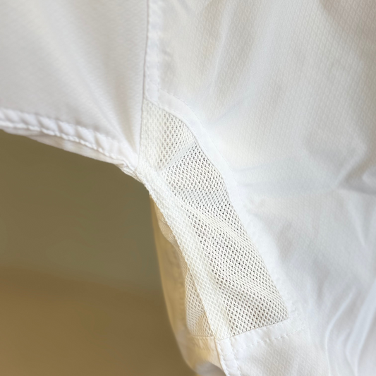 Close-up of a white shirt with a patch on the shoulder