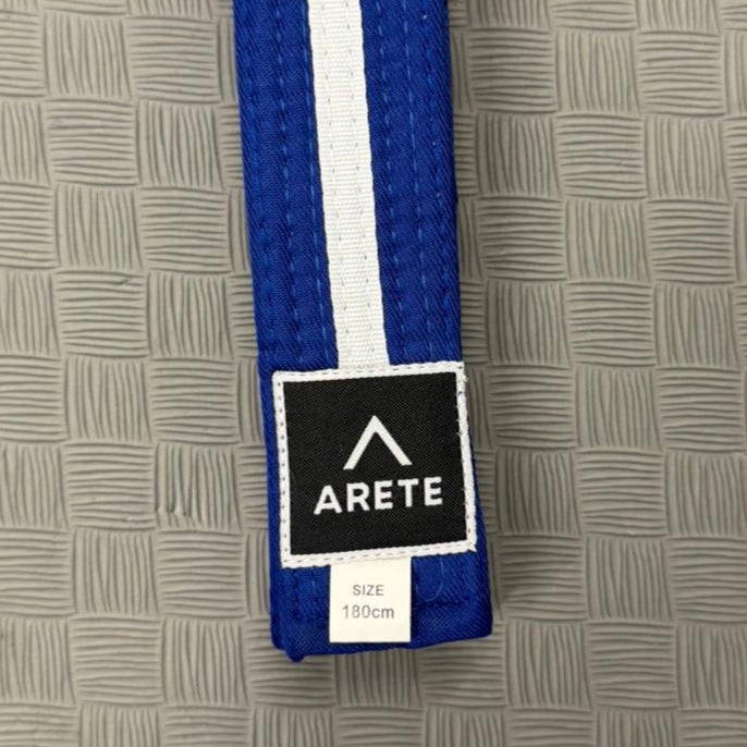 Blue and white belt with Arete logo on a textured gray background