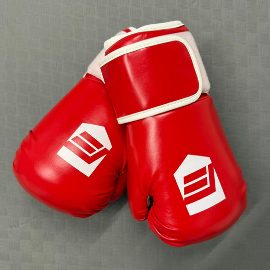 Red boxing gloves with a white logo on a gray background