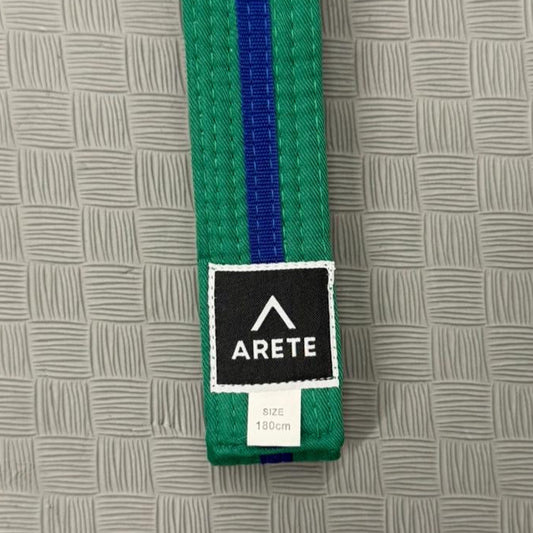 Green belt with a blue stripe and Arete label on a textured gray background