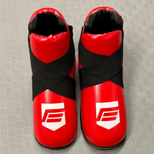 Red and black protective foot pads on a grey mat