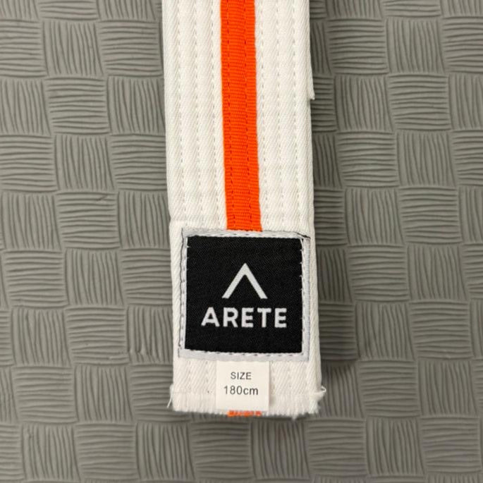 White belt with red stripes and Arete logo on a gray textured background