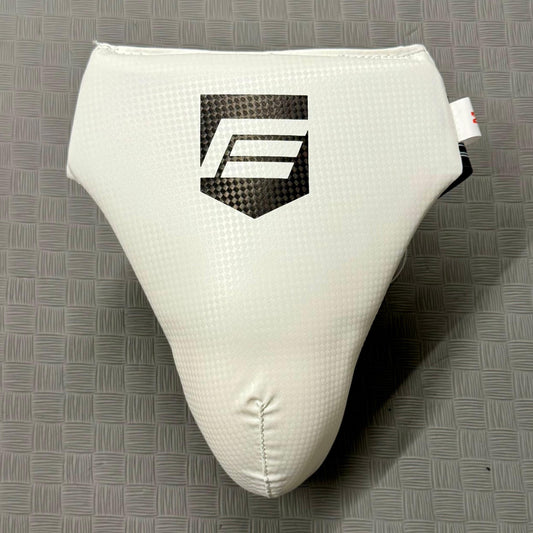 White groin guard with a logo on a grey mat